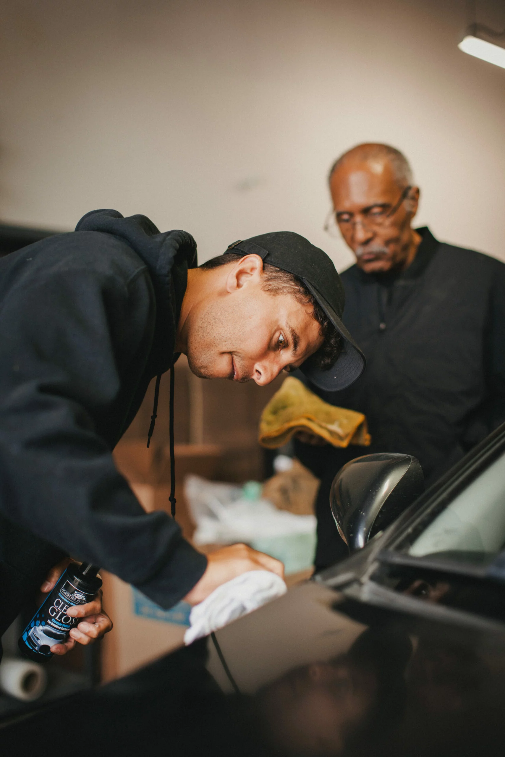 Two men polishing a car finish by hand with CJ's Master Formula
